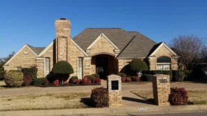 Completed asphalt shingle roof replacement on a brick home in North Texas by Rocking J Construction