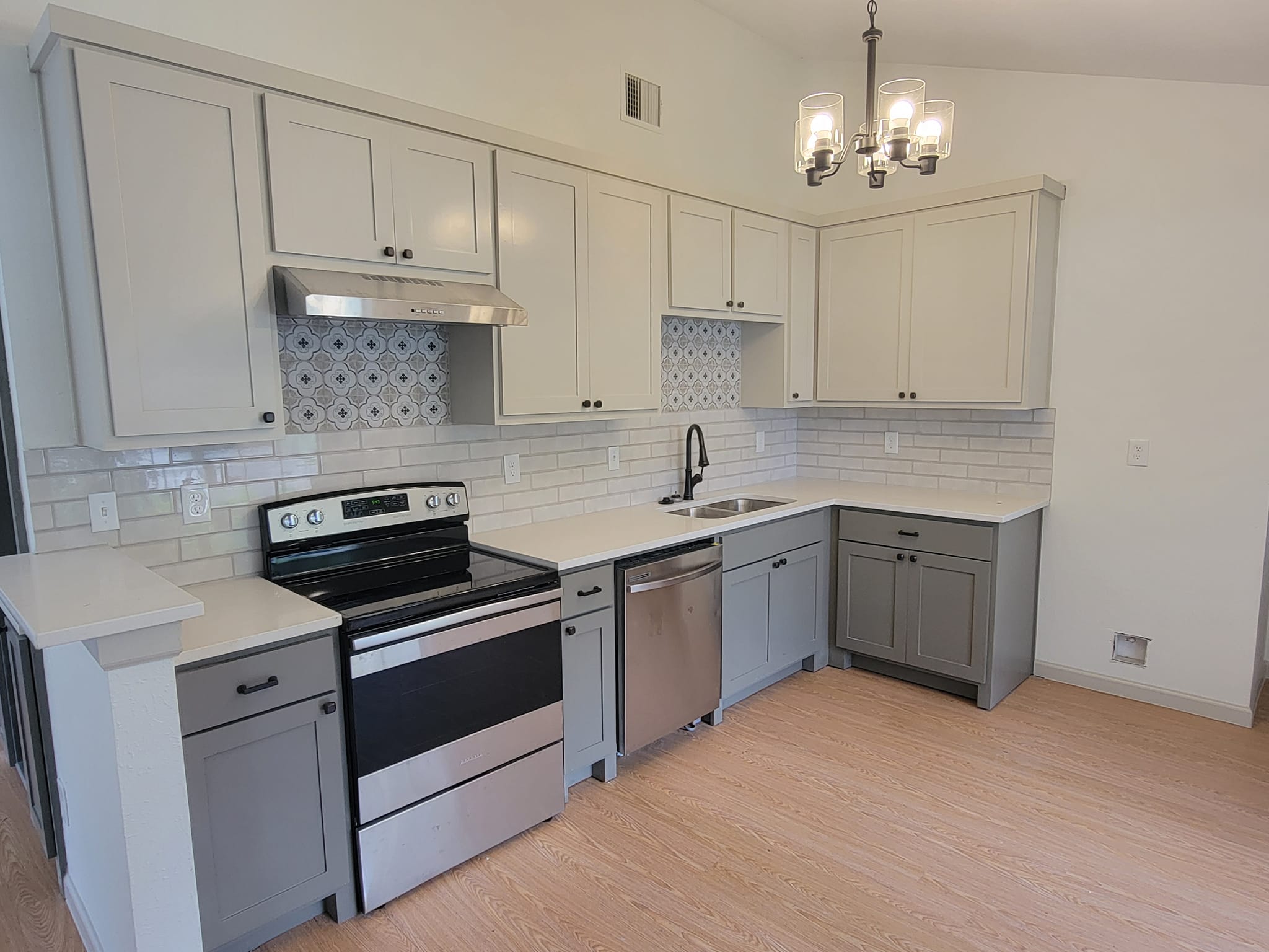 Kitchen remodel with three-faced cabinets and quartz countertop.