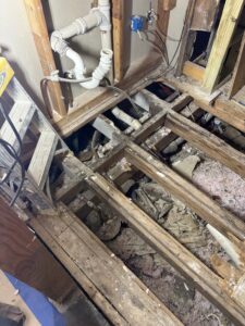 Rotted floor joists exposed during bathroom remodel demolition in Carrollton, TX